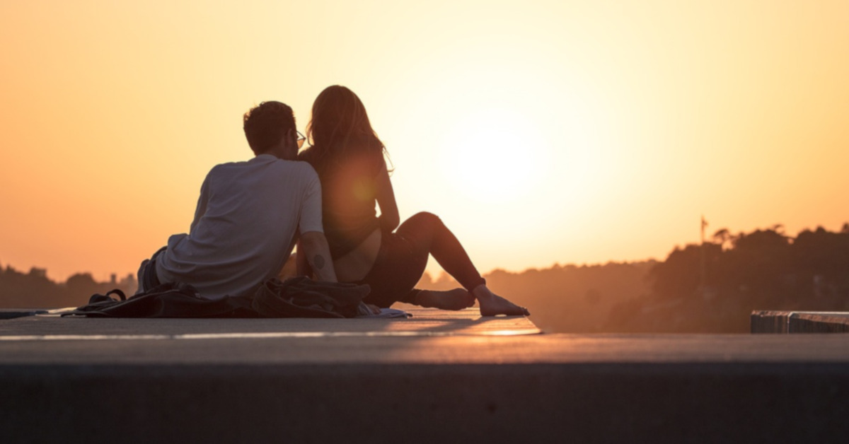 couple enjoying a sunset - aifc